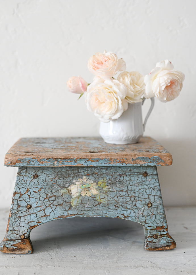 White roses on vintage chippy blue stool